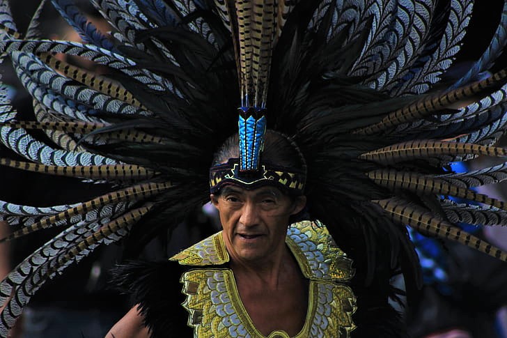 A person wearing a traditional headdress and clothing.
