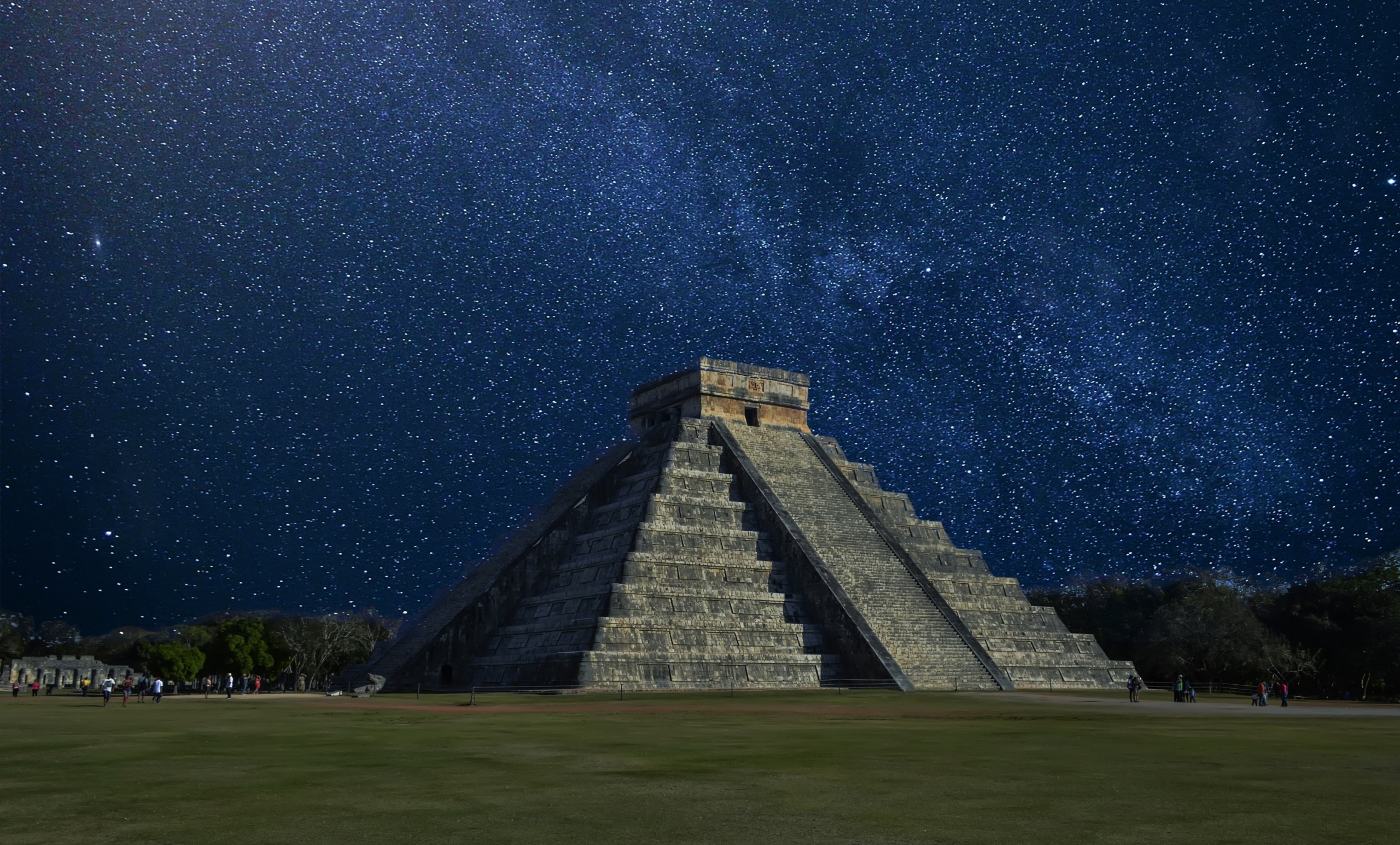 The Temple of Kukulcán, a Mesoamerican step-pyramid, against the night sky.